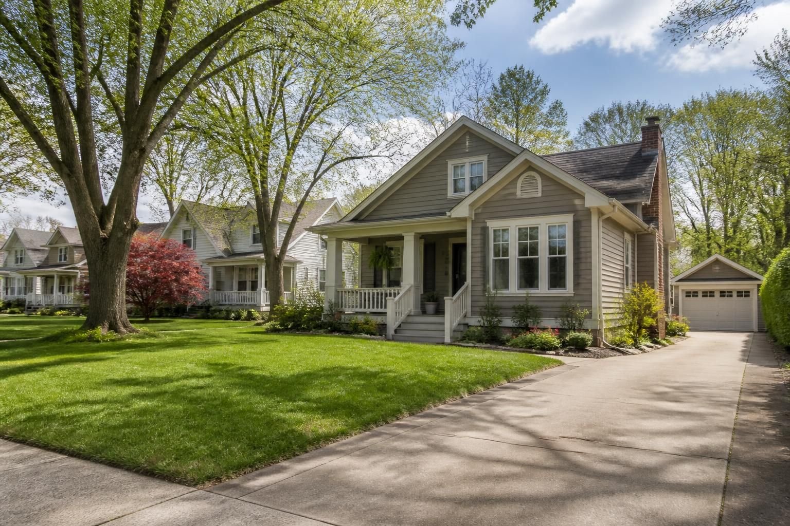 Small-town neighborhood with neat lawns and a clean driveway