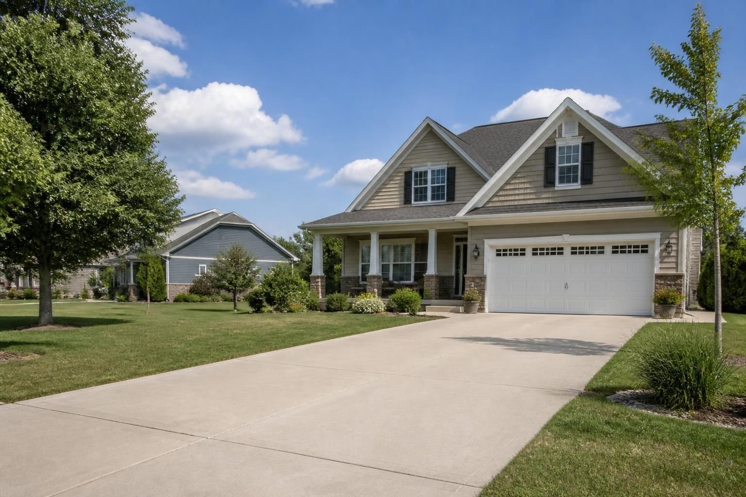 Country-suburban neighborhood with a clean concrete driveway